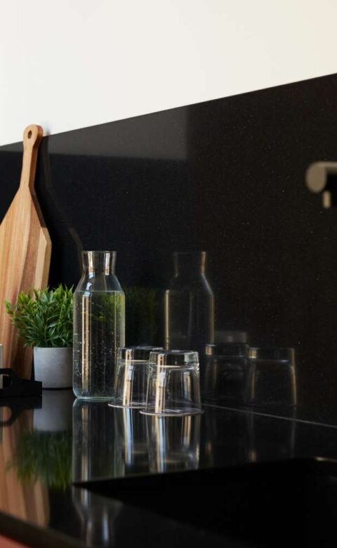 a black counter top with a wooden cutting board