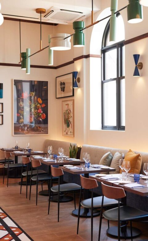 a dining room with a couch, table and chairs