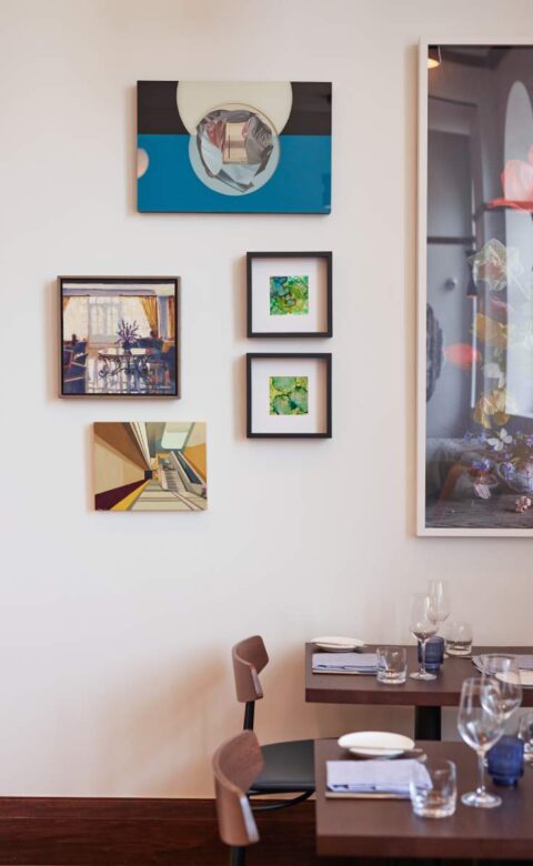 2 table and chair with photo frame on wall