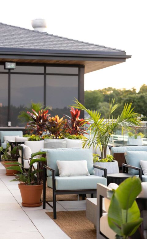 a couple of chairs sitting next to each other on a patio