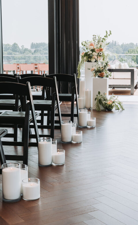 a row of chairs with candles on the floor