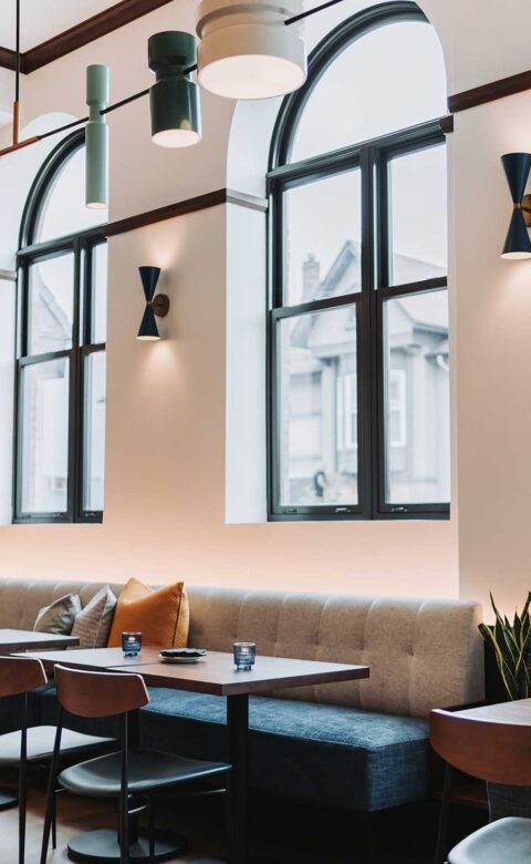 restaurant half booth in front of window with arched top