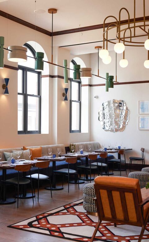 half booth seating in restaurant in front of windows with arched tops