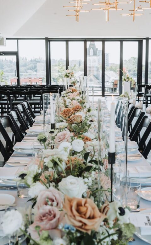 a long table set with flowers and place settings