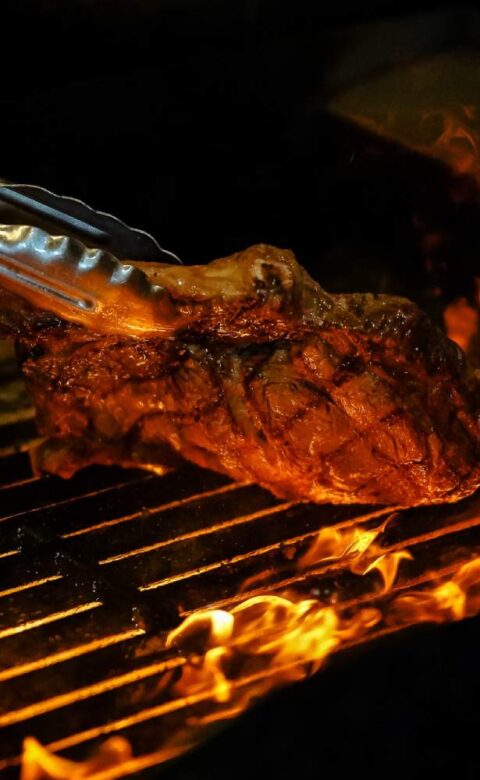 a steak is being cooked on a grill