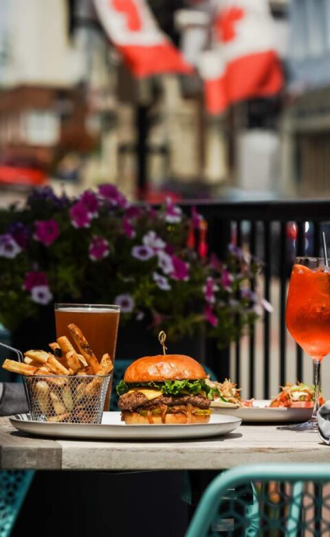 a table topped with a plate of food next to a glass of wine