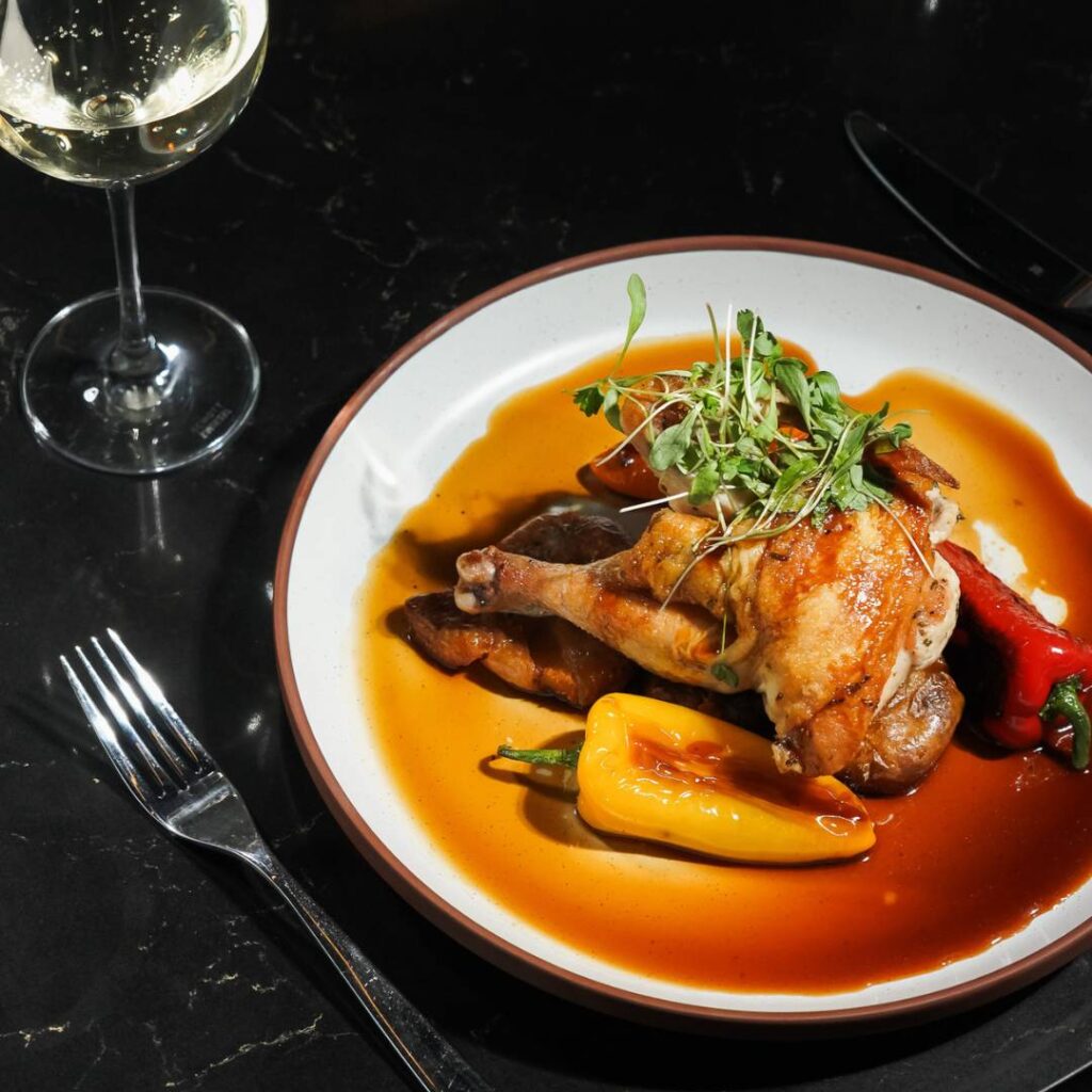 plate of food and a glass of wine on a table